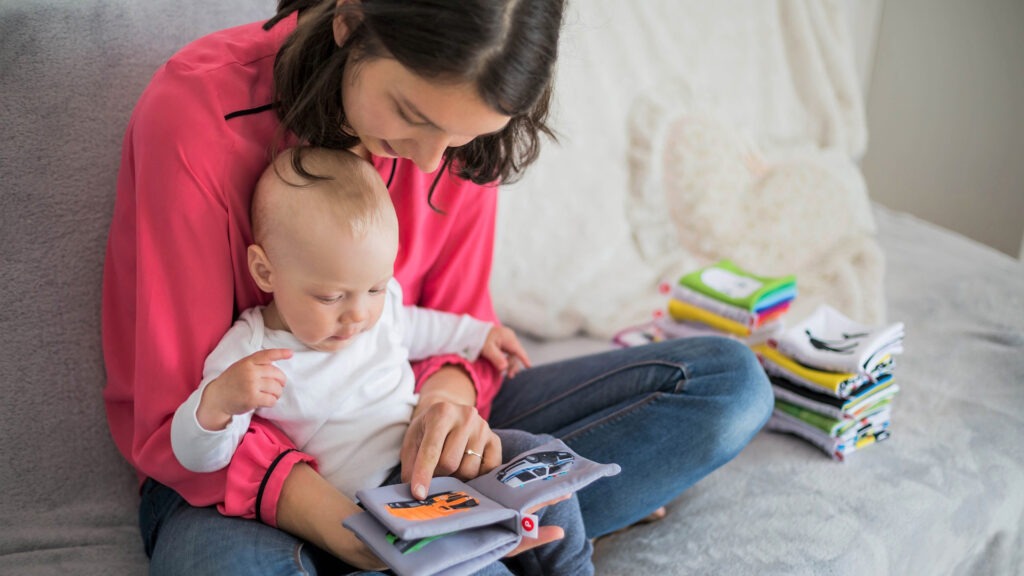 A mother and her child reading a book together.