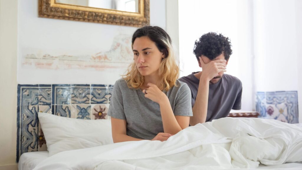 A couple upset in the bedroom. From the article: Signs an avoidant is done with you.