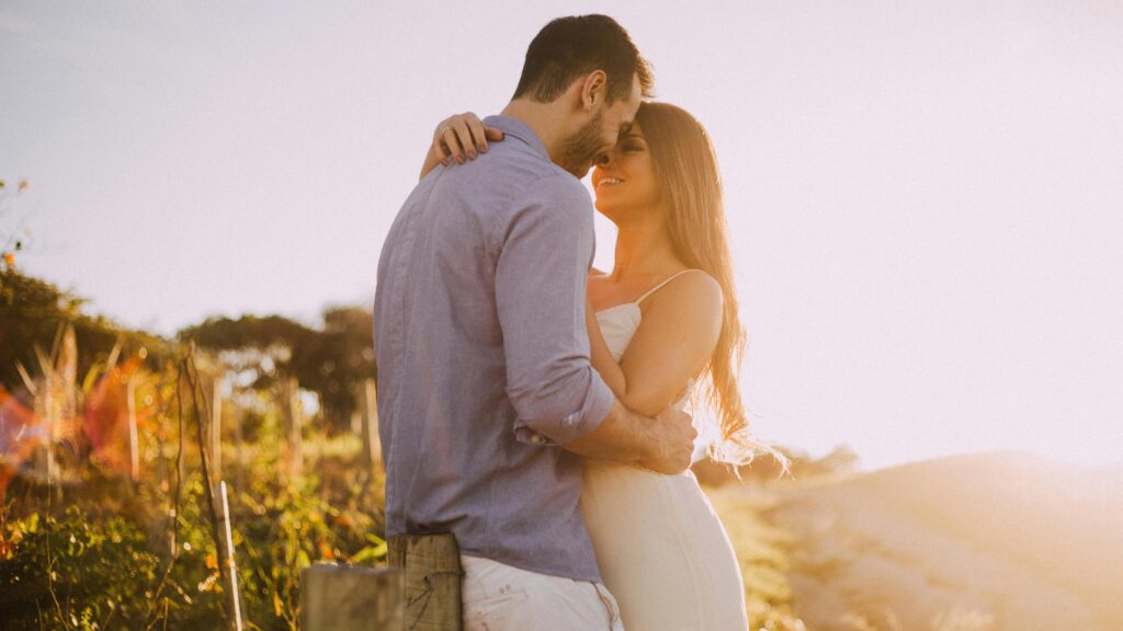 A young couple embraces during the golden hour. From the article: "How to cultivate a secure attachment as an adult"